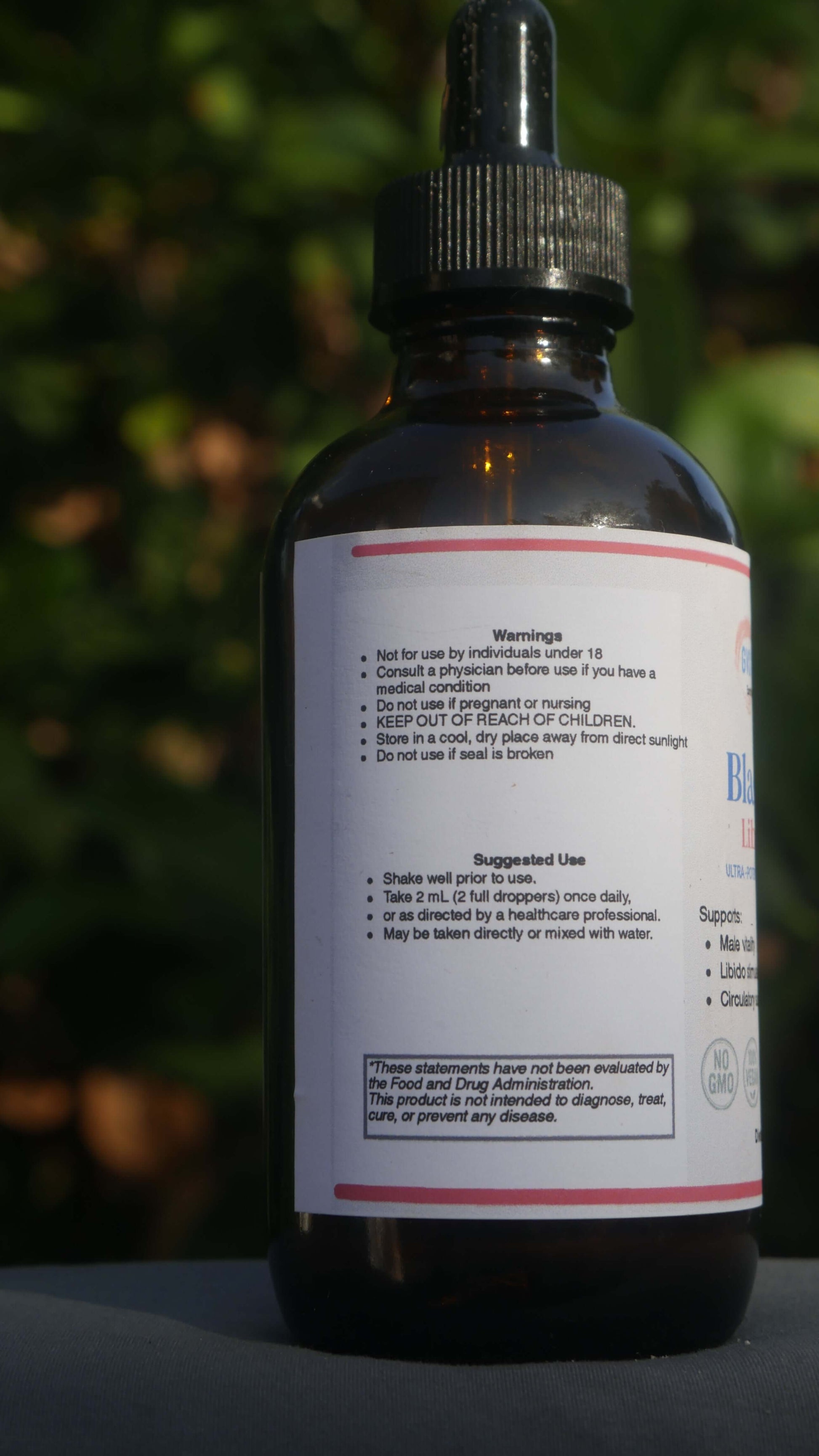 Black Label Libido Complex bottle with usage instructions and warnings on the label.