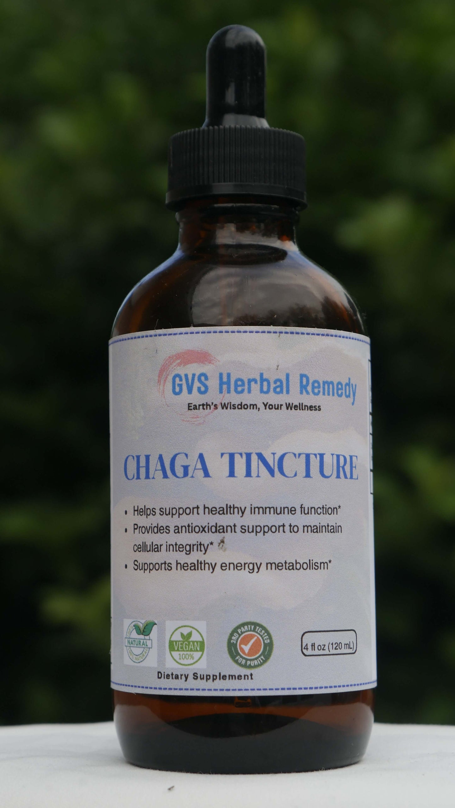 Chaga Tincture with a label on a blurred green background