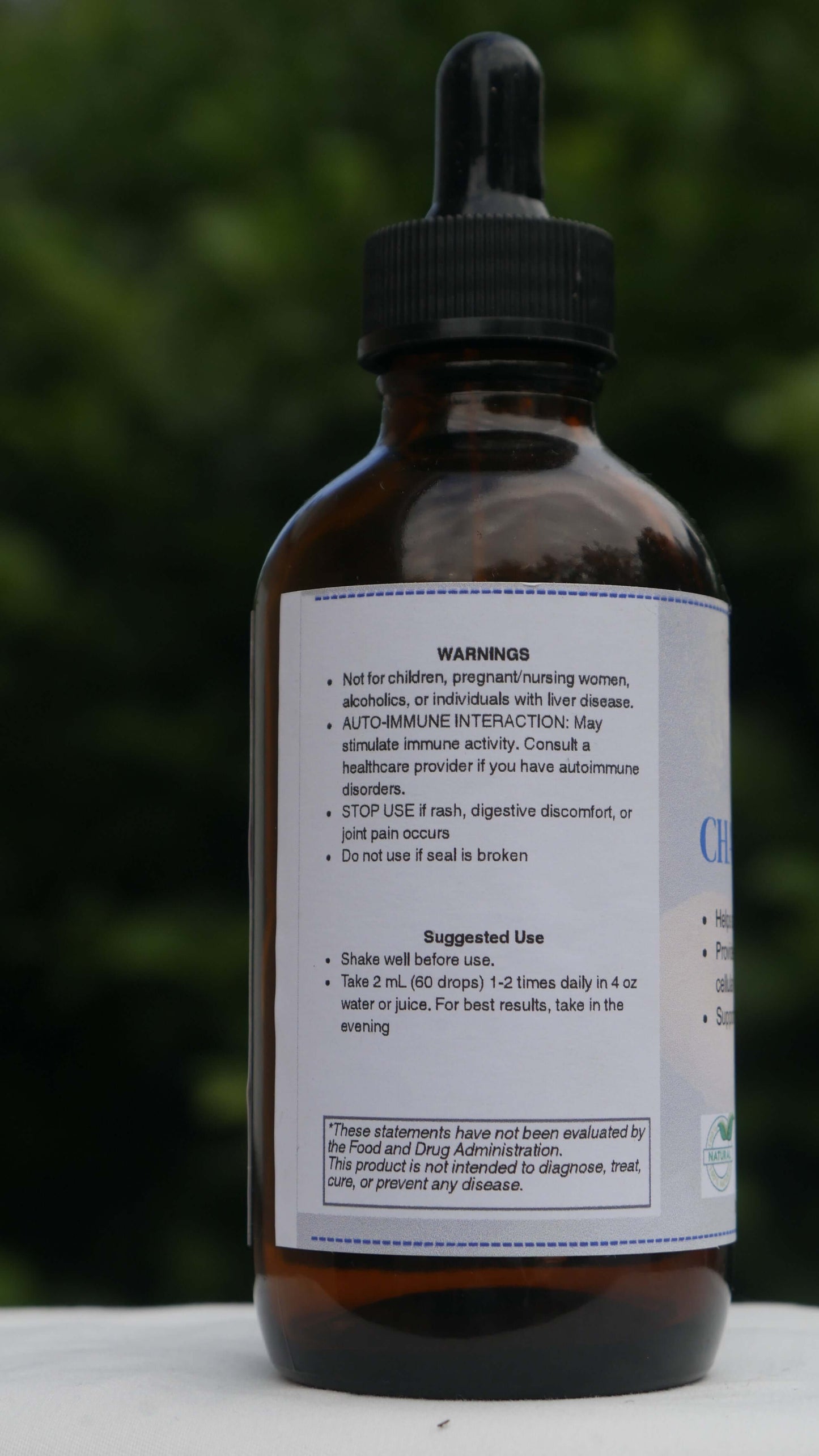 Chaga Tincture with a label on a blurred green background