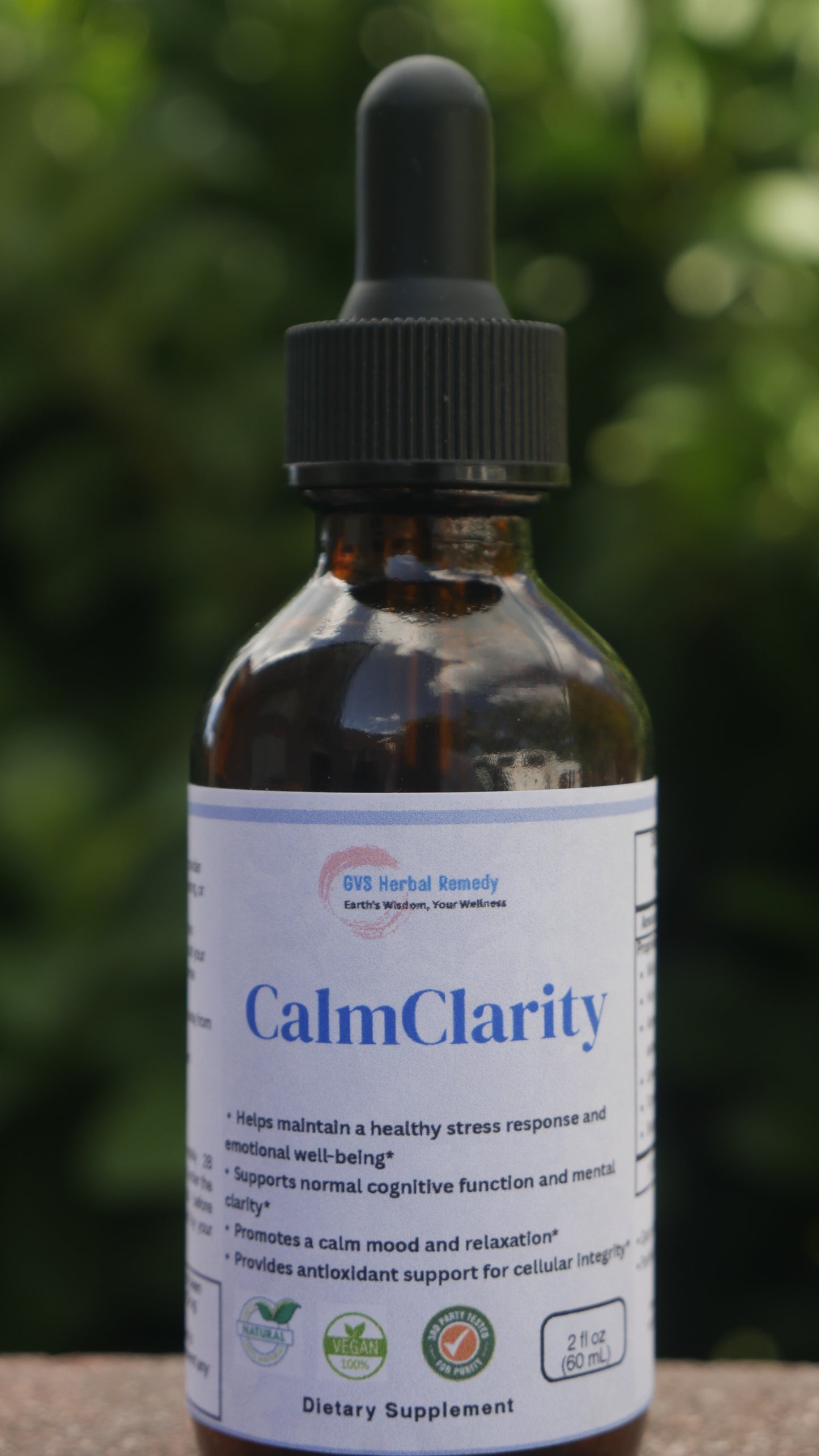 Bottle of 'CalmClarity' supplement with a dropper on a blurred green background