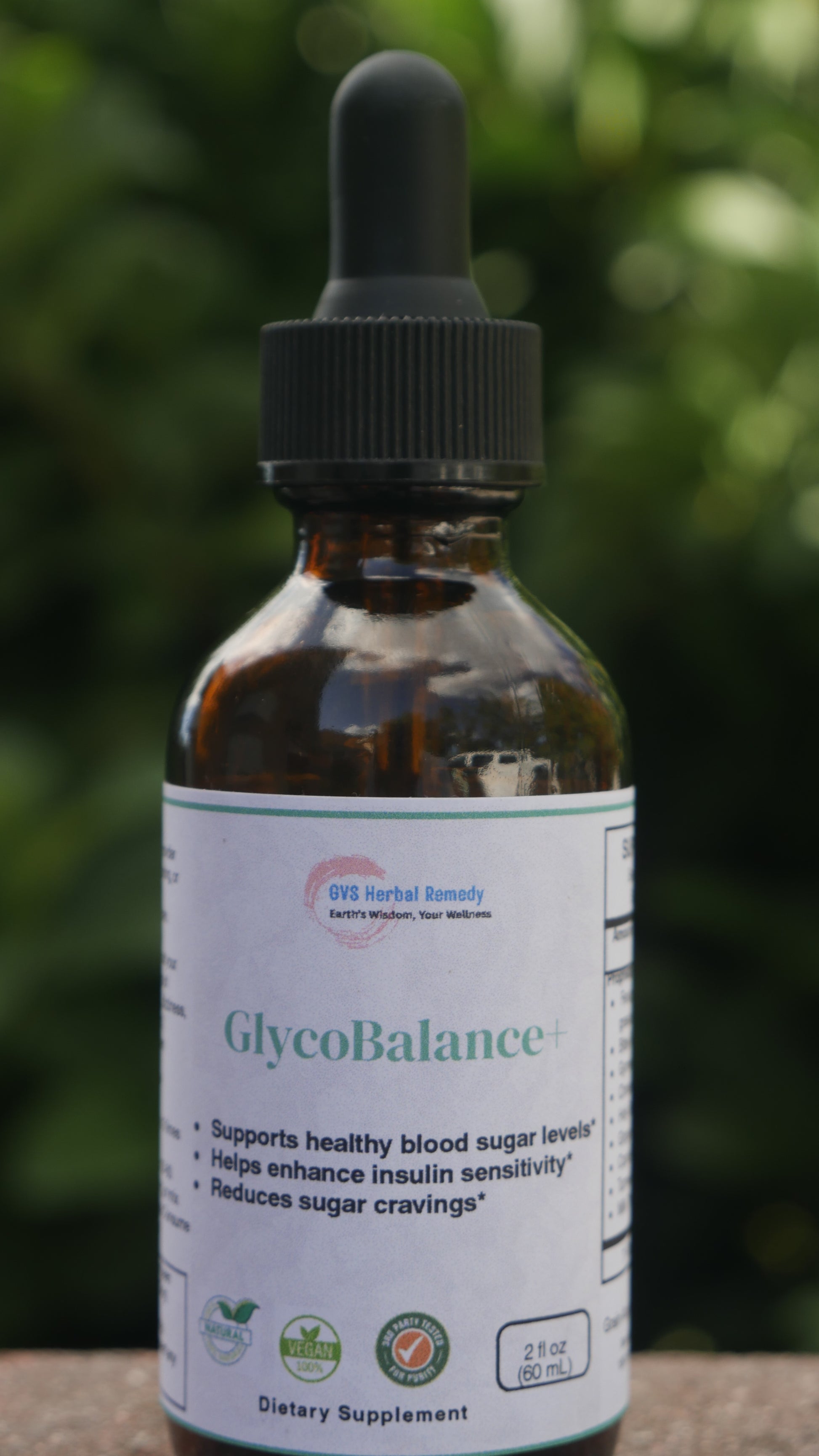 Bottle of GlycoBalance supplement with a blurred green background