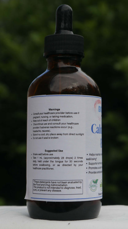 Bottle of CalmClarity Elixir with a blurred green background