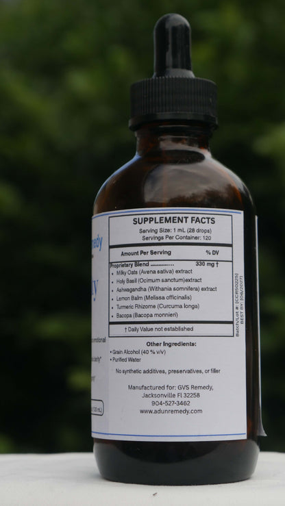 Bottle of CalmClarity Elixir with a blurred green background